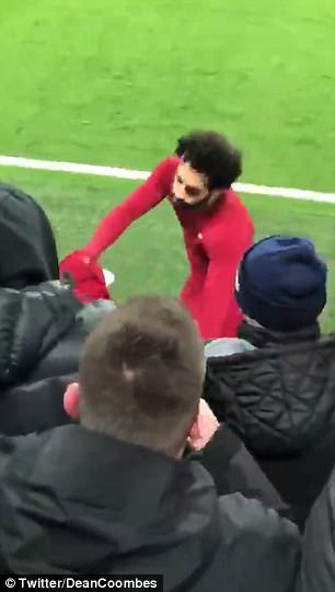 Salah happily handed over his shirt to the young Liverpool supporter after full time